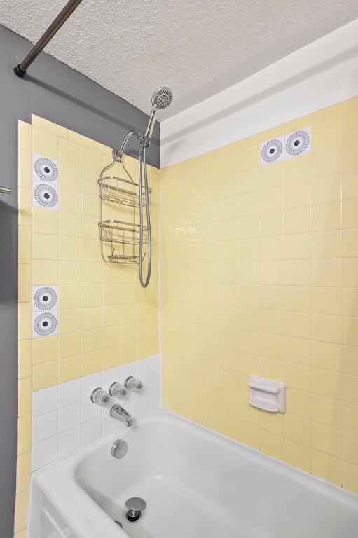 2425 Ashdale Dr Unit 78, Austin, TX 78757 - bathroom featuring a textured ceiling and  shower combination