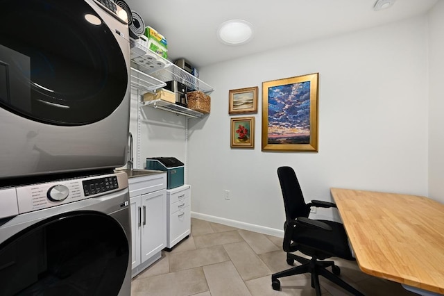 5708 Bullard Dr, Austin, TX 78757 - laundry room with cabinet space, baseboards, light tile patterned floors, and stacked washer and clothes dryer