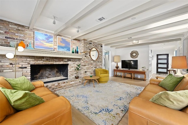 5708 Bullard Dr, Austin, TX 78757 - living area featuring visible vents, a brick fireplace, wood finished floors, and brick wall