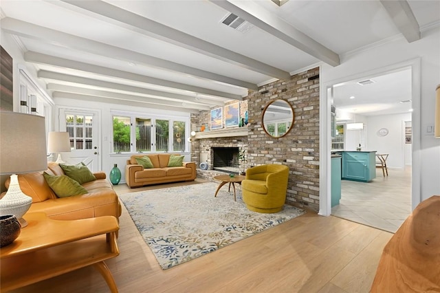 5708 Bullard Dr, Austin, TX 78757 - living area with a brick fireplace, beamed ceiling, visible vents, and light wood-type flooring