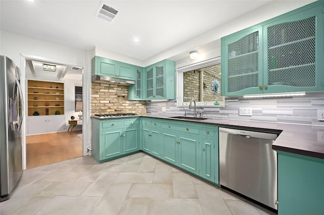 5708 Bullard Dr, Austin, TX 78757 - kitchen featuring decorative backsplash, visible vents, stainless steel appliances, a sink, and under cabinet range hood