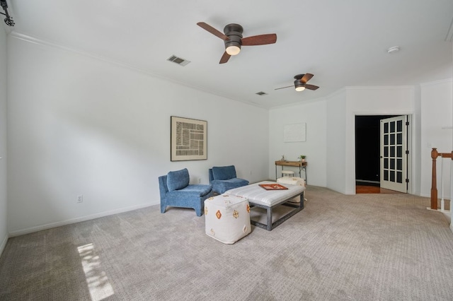 sitting room featuring crown molding, carpet floors, ceiling fan, and visible vents