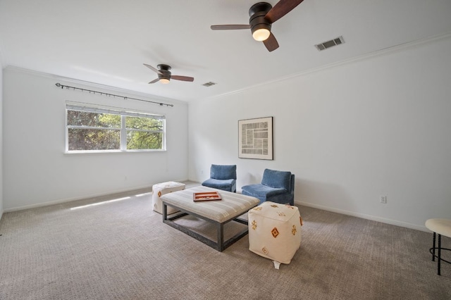 living area with ceiling fan, ornamental molding, visible vents, and carpet floors