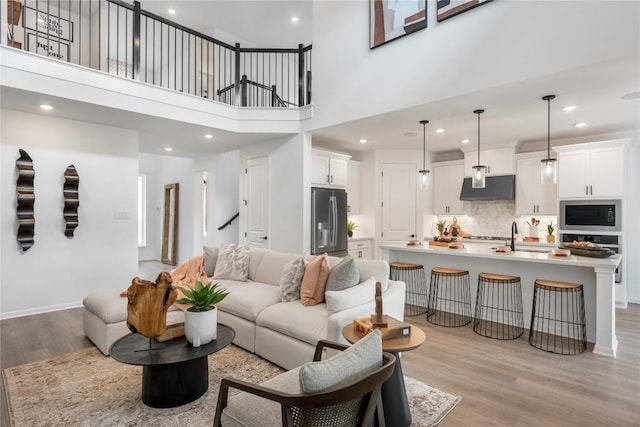 120 Amber Oak Ln, Georgetown, TX 78628 - living room featuring light wood-style floors, recessed lighting, and a towering ceiling