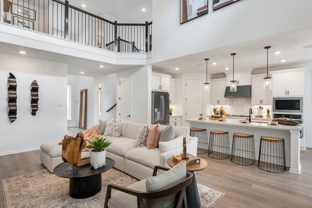 120 Amber Oak Ln, Georgetown, TX 78628 - living room with light wood-style flooring, recessed lighting, and a high ceiling