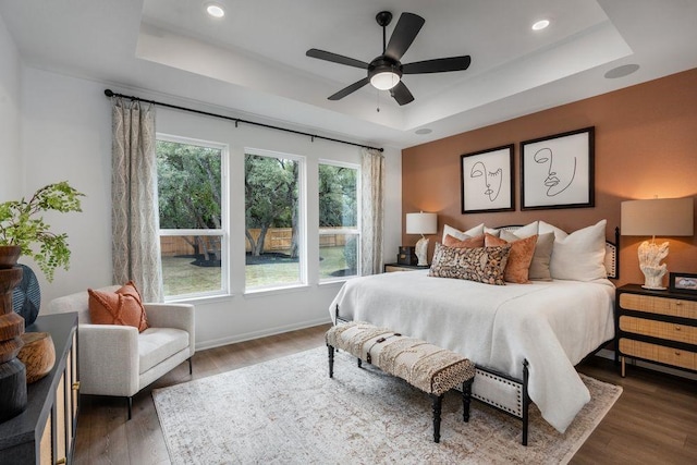 120 Amber Oak Ln, Georgetown, TX 78628 - bedroom featuring a raised ceiling, wood finished floors, recessed lighting, and ceiling fan