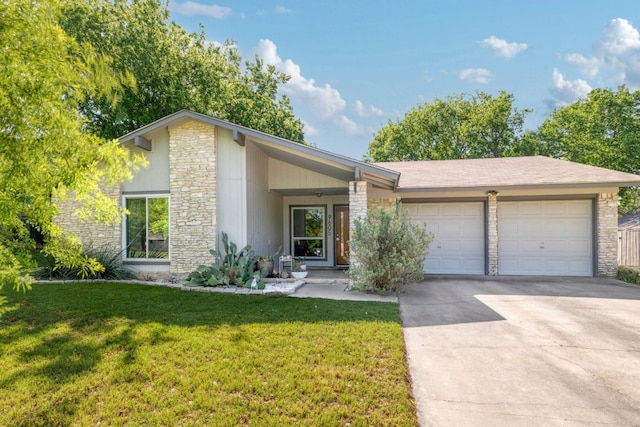 9605 Marston Ln, Austin, TX 78753 - mid-century inspired home with stone siding, an attached garage, driveway, and a front yard