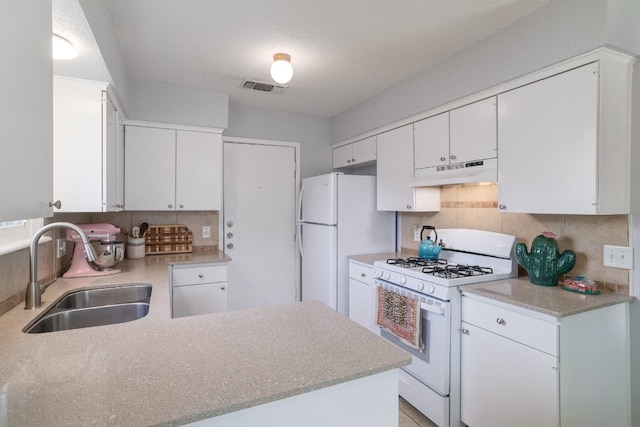 9605 Marston Ln, Austin, TX 78753 - kitchen with white appliances, a sink, under cabinet range hood, and backsplash