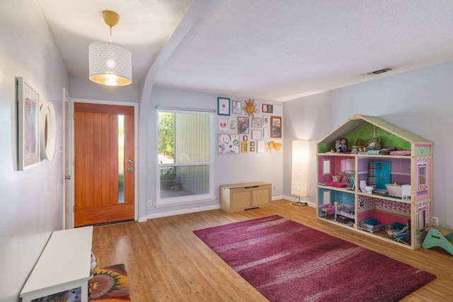 9605 Marston Ln, Austin, TX 78753 - entrance foyer with wood finished floors, baseboards, and a textured ceiling
