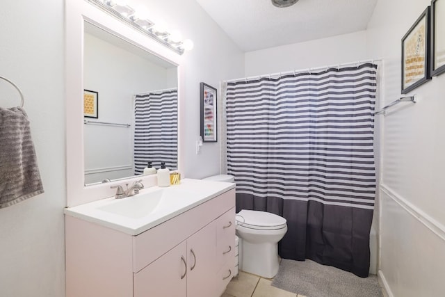 9605 Marston Ln, Austin, TX 78753 - full bathroom with vanity, toilet, tile patterned floors, and a shower with shower curtain