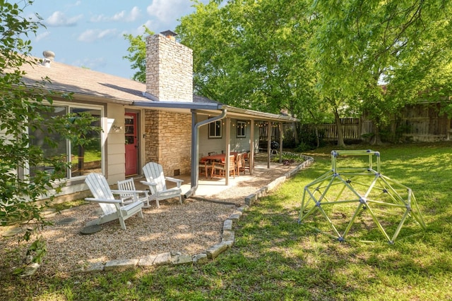 9605 Marston Ln, Austin, TX 78753 - rear view of house featuring a chimney, a patio, and stone siding