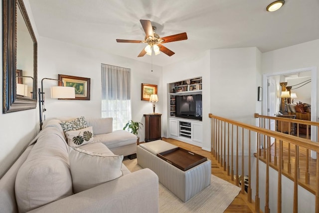 515 Coventry Rd, Spicewood, TX 78669 - living room with ceiling fan, built in shelves, and light wood-style floors