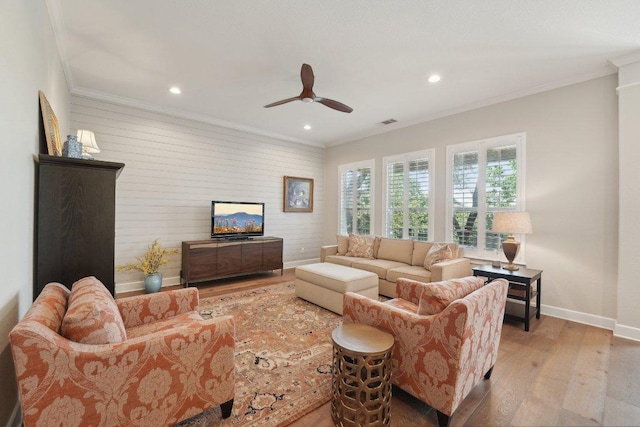 living room with crown molding, wood finished floors, ceiling fan, baseboards, and recessed lighting