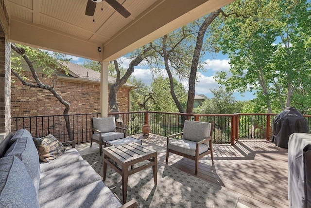 wooden deck with ceiling fan and an outdoor living space