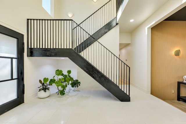 9909 Oliver Dr, Austin, TX 78736 - stairs with plenty of natural light, baseboards, and tile patterned flooring