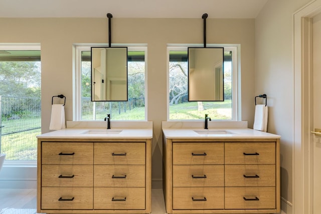 9909 Oliver Dr, Austin, TX 78736 - full bathroom featuring two vanities and baseboards