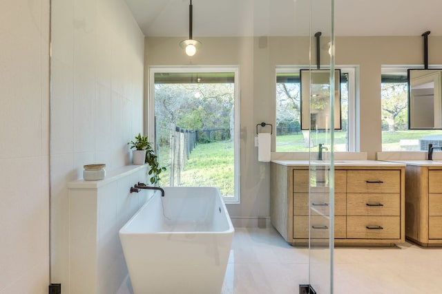 9909 Oliver Dr, Austin, TX 78736 - bathroom featuring vanity, a soaking tub, tile patterned flooring, and plenty of natural light