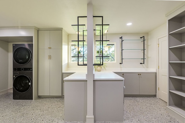 9909 Oliver Dr, Austin, TX 78736 - laundry area with stacked washer / dryer, cabinet space, and recessed lighting