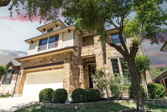 121 E Adelanta Pl, Round Rock, TX 78681 - view of front facade featuring stone siding, a garage, and concrete driveway