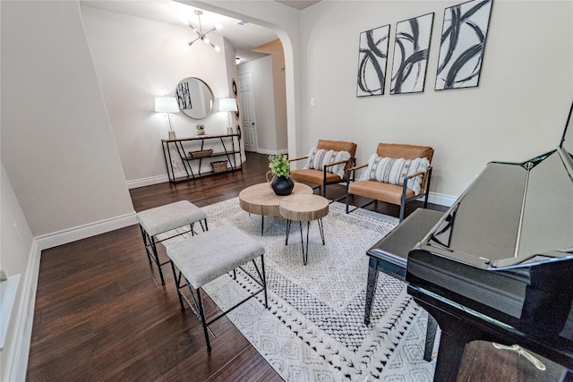 121 E Adelanta Pl, Round Rock, TX 78681 - sitting room with wood finished floors, baseboards, and arched walkways