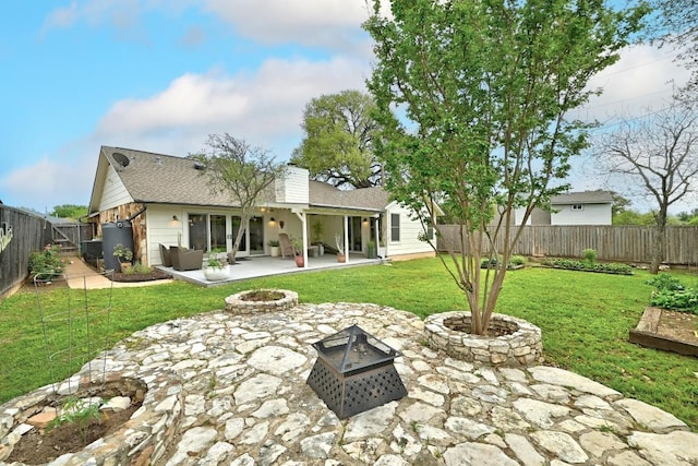 6567 Fair Valley Trl, Austin, TX 78749 - back of property featuring a fire pit, a patio, a fenced backyard, a chimney, and a shingled roof