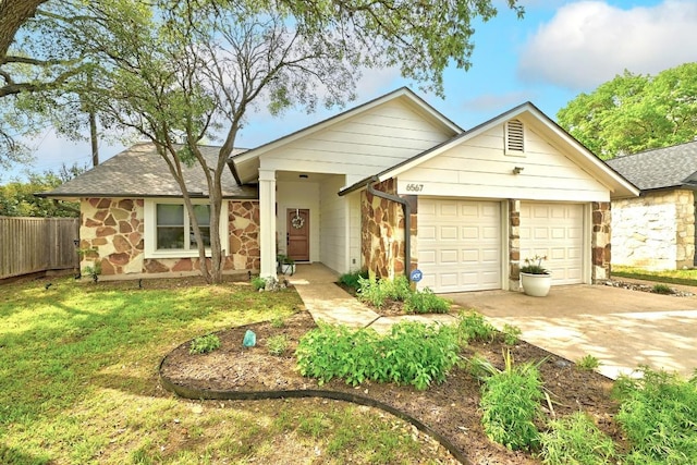 6567 Fair Valley Trl, Austin, TX 78749 - single story home with stone siding, an attached garage, driveway, and roof with shingles