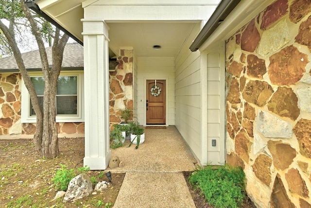 6567 Fair Valley Trl, Austin, TX 78749 - view of exterior entry with a shingled roof and stone siding