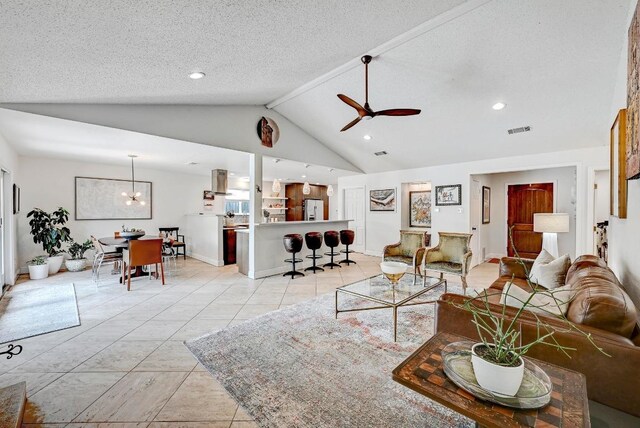 6567 Fair Valley Trl, Austin, TX 78749 - living room featuring ceiling fan, vaulted ceiling, light tile patterned floors, a textured ceiling, and recessed lighting