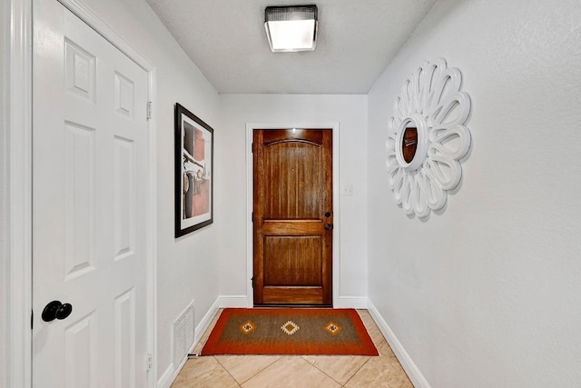 6567 Fair Valley Trl, Austin, TX 78749 - doorway with light tile patterned floors and baseboards