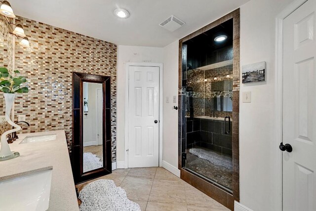 6567 Fair Valley Trl, Austin, TX 78749 - bathroom with a shower stall, double vanity, and tile patterned floors