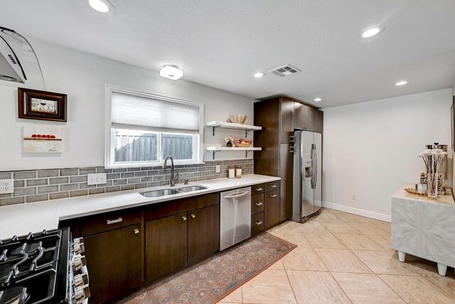6567 Fair Valley Trl, Austin, TX 78749 - kitchen with stainless steel appliances, dark brown cabinets, backsplash, light countertops, and recessed lighting