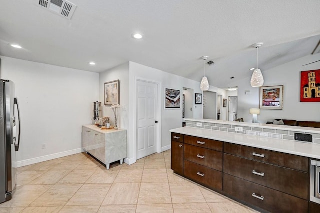6567 Fair Valley Trl, Austin, TX 78749 - kitchen featuring freestanding refrigerator, dark brown cabinetry, light countertops, recessed lighting, and hanging light fixtures