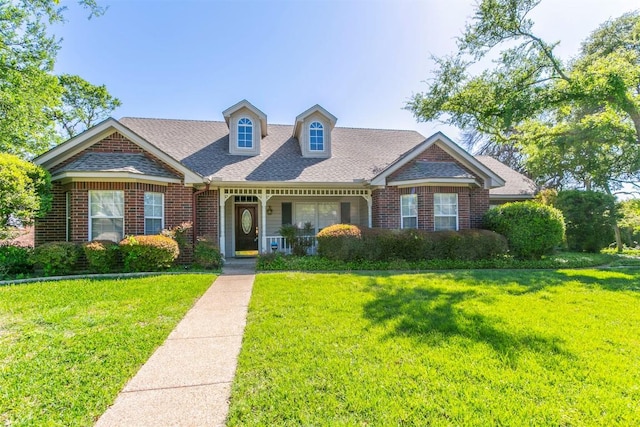 2603 Taylor Ridge Rd, Temple, TX 76502 - view of front of home with a shingled roof, covered porch, a front lawn, and brick siding