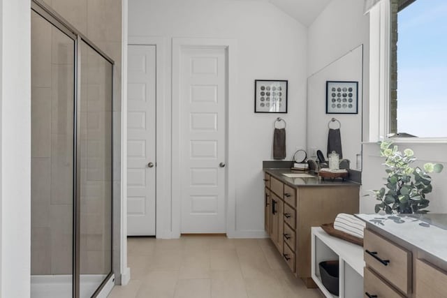 13615 Thomas Wheeler Way, Manor, TX 78653 - full bathroom with a shower stall, vanity, tile patterned flooring, and lofted ceiling