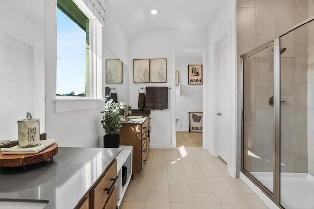 13615 Thomas Wheeler Way, Manor, TX 78653 - bathroom featuring vanity, a stall shower, tile patterned flooring, lofted ceiling, and recessed lighting