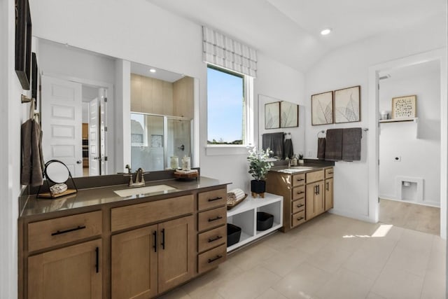 13615 Thomas Wheeler Way, Manor, TX 78653 - full bathroom featuring a shower stall, two vanities, lofted ceiling, recessed lighting, and tile patterned floors