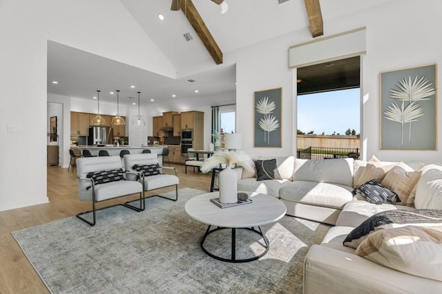 13615 Thomas Wheeler Way, Manor, TX 78653 - living room with light wood-style floors, recessed lighting, beamed ceiling, ceiling fan, and high vaulted ceiling
