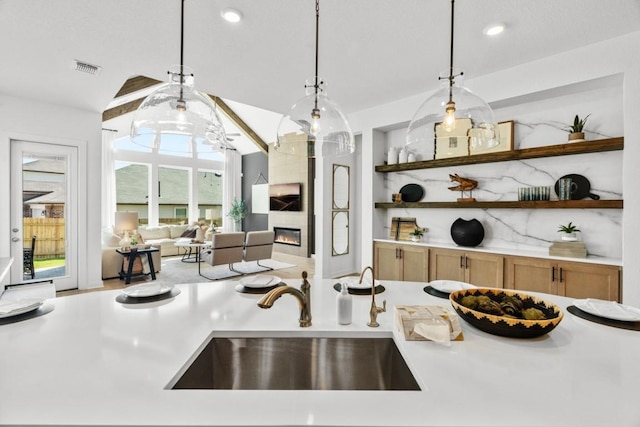 13615 Thomas Wheeler Way, Manor, TX 78653 - kitchen featuring light countertops, a sink, pendant lighting, open shelves, and recessed lighting