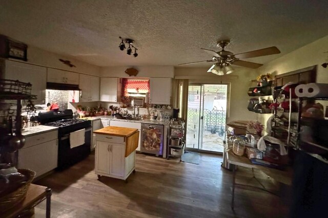 5501 Hibiscus Dr, Austin, TX 78724 - kitchen featuring black range with gas stovetop, wood counters, dishwasher, ceiling fan, and under cabinet range hood
