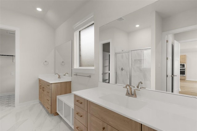 13504 Thomas Wheeler Way, Manor, TX 78653 - bathroom featuring a stall shower, two vanities, recessed lighting, and marble look tiles