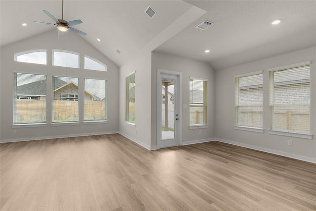 13504 Thomas Wheeler Way, Manor, TX 78653 - unfurnished living room featuring light wood-style floors, vaulted ceiling, ceiling fan, baseboards, and recessed lighting