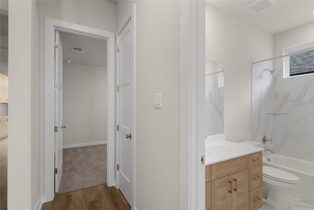 13504 Thomas Wheeler Way, Manor, TX 78653 - full bath featuring vanity, washtub / shower combination, toilet, and wood finished floors