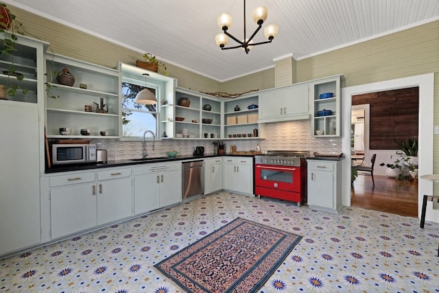 2124 Bluebonnet Ln, Austin, TX 78704 - kitchen featuring appliances with stainless steel finishes, open shelves, dark countertops, a chandelier, and light floors