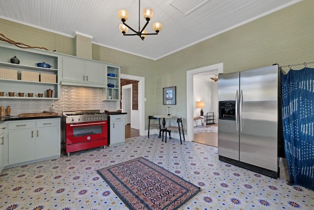 2124 Bluebonnet Ln, Austin, TX 78704 - kitchen with stainless steel appliances, open shelves, a chandelier, dark countertops, and light flooring