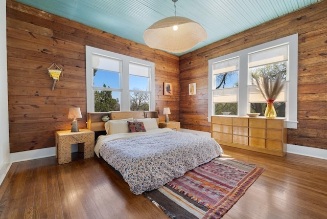 2124 Bluebonnet Ln, Austin, TX 78704 - bedroom with wood-type flooring and wooden walls