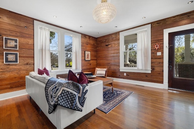 2124 Bluebonnet Ln, Austin, TX 78704 - living area featuring wood walls, wood finished floors, and a chandelier