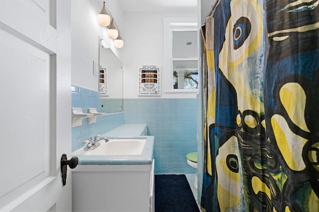 2124 Bluebonnet Ln, Austin, TX 78704 - bathroom with vanity, tile walls, wainscoting, curtained shower, and tile patterned flooring