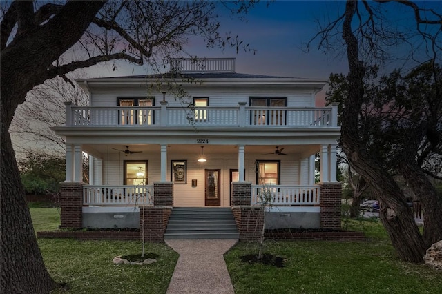 2124 Bluebonnet Ln, Austin, TX 78704 - american foursquare style home with a balcony, a porch, a ceiling fan, and a front lawn