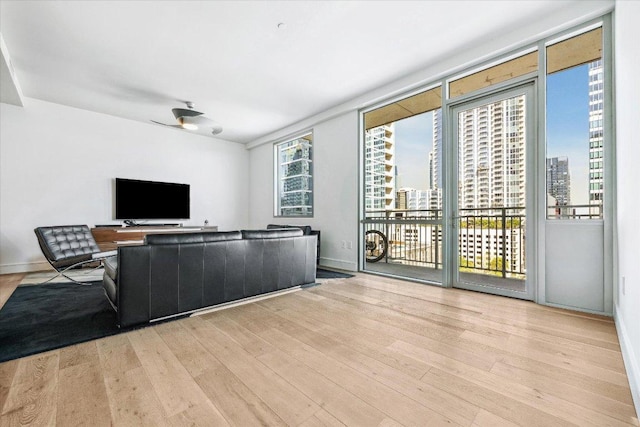 222 W Ave Unit 1213, Austin, TX 78701 - living room featuring wood finished floors, a view of city, and baseboards