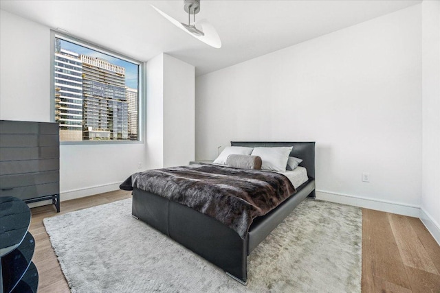 222 W Ave Unit 1213, Austin, TX 78701 - bedroom with baseboards and wood finished floors